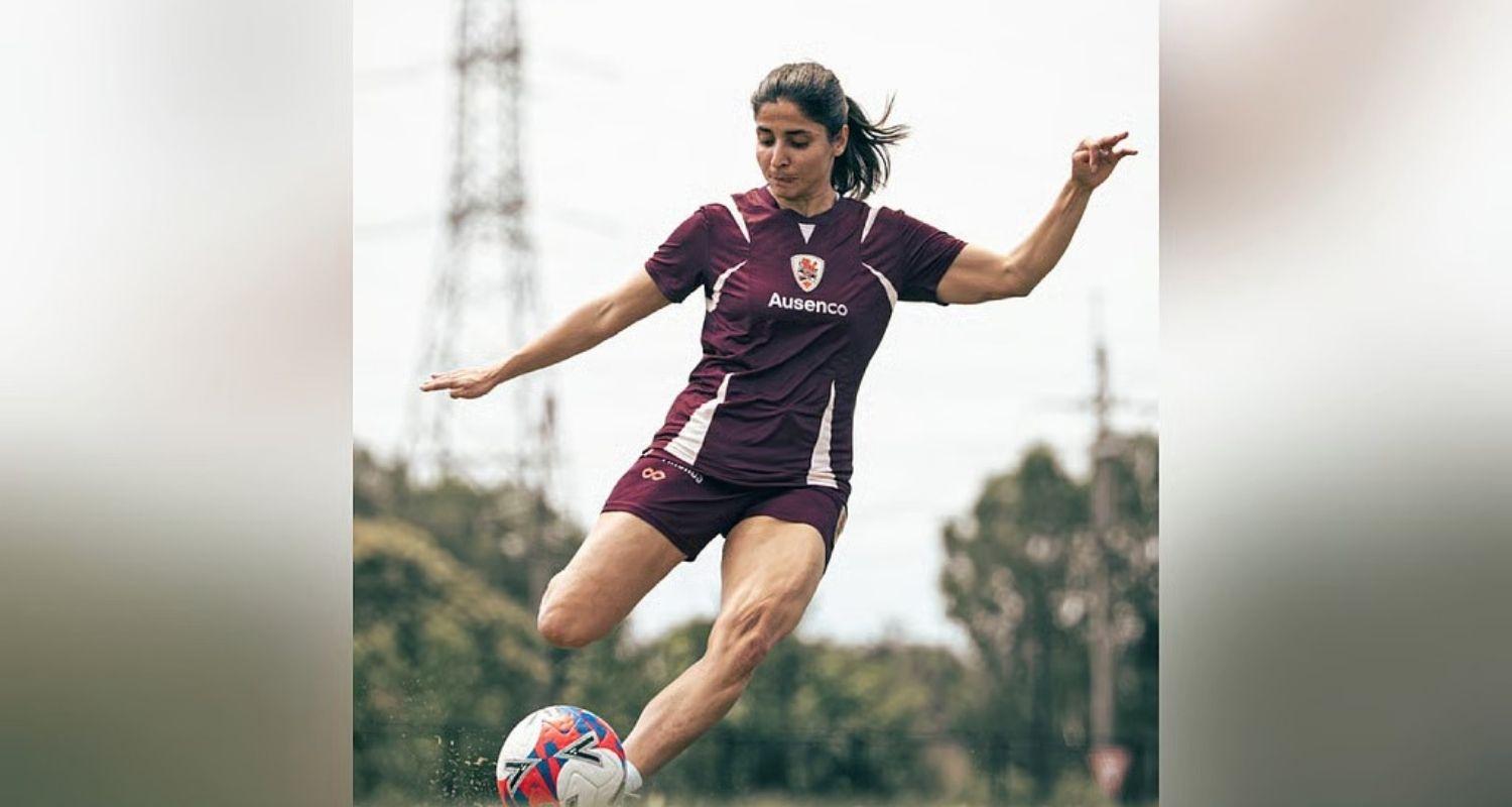 Iranian football player Atefeh Ramezanisadeh kicks a ball at a Brisbane Roar club training session in Australia.