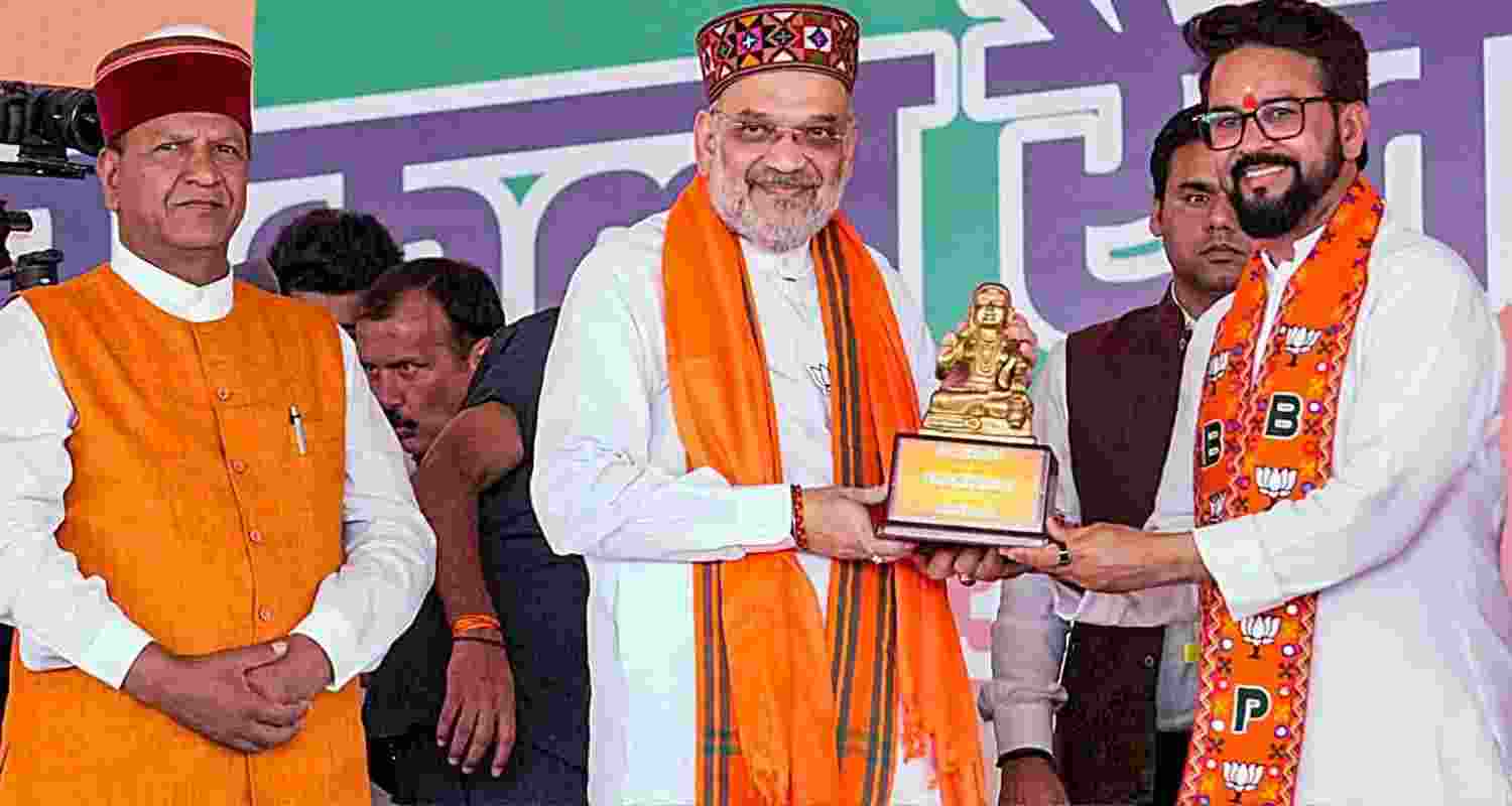 Union Home Minister and BJP leader Amit Shah being felicitated by BJP candidate from Hamirpur Lok Sabha constituency Anurag Thakur during a campaign rally for Lok Sabha polls, in Una, on Saturday. 