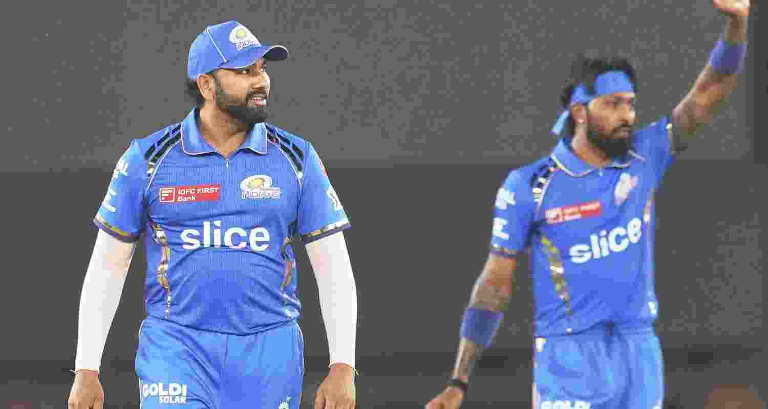Former Mumbai Indians captain Rohit Sharma with the new skipper Hardik Pandya.