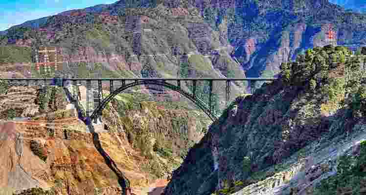 The image shows the Chenab Rail Bridge, a key component of the Udhampur-Srinagar-Baramulla Railway Link (USBRL) project, situated over the Chenab river in Reasi district, known as the world’s highest railway bridge. 