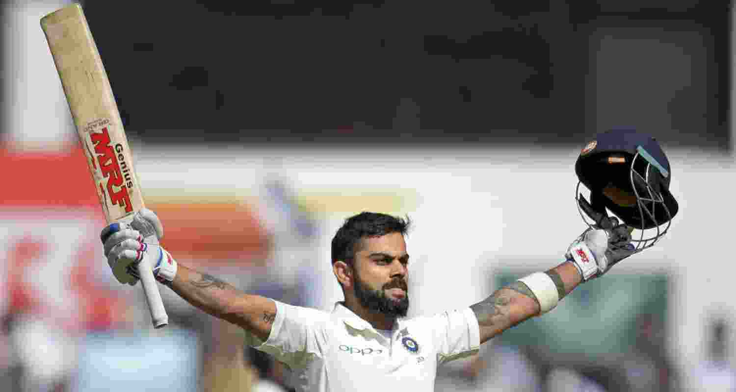 Virat Kohli celebrates a century 