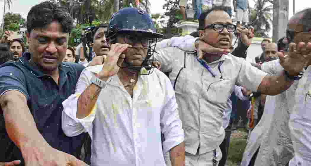 TMC general secretary Abhishek Banerjee wears a helmet after stones, shoes and eggs were hurled at him during his visit to meet families of post-poll violence victims, in Sonarpur, West Bengal on Saturday. (PTI)