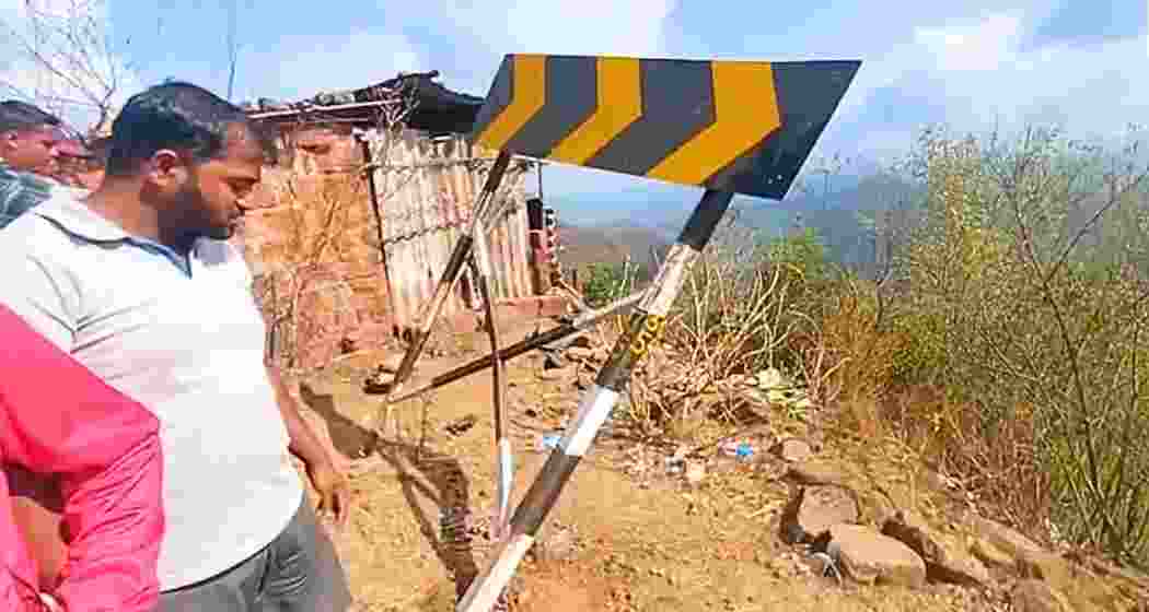 A man looks at the site where an SUV plunged into a deep gorge in Maharashtra’s Raigad district.