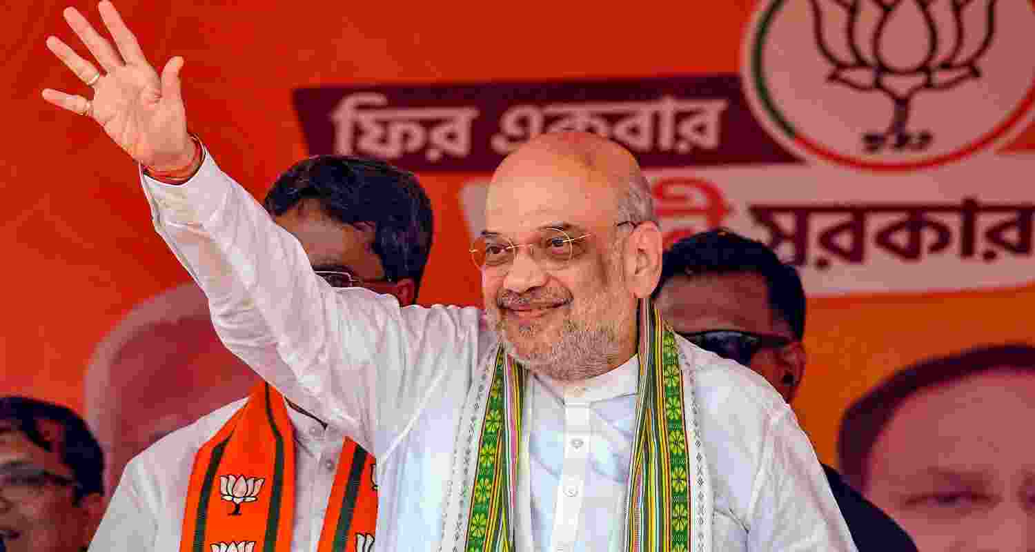 Union Home Minister and BJP leader Amit Shah waves at supporters during a public meeting, ahead of Lok Sabha elections, in Kumarghat, Tripura on Monday. Union Home Minister and BJP leader Amit Shah waves at supporters during a public meeting, ahead of Lok Sabha elections, in Kumarghat, Tripura on Monday.
