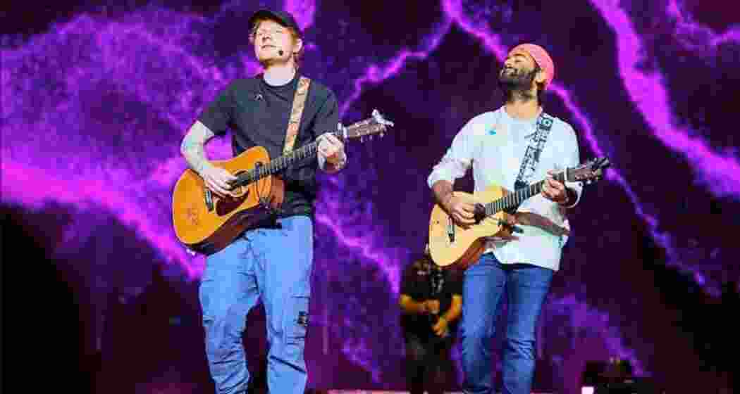 Ed Sheeran (left) shares the stage with Arijit Singh (right) during a live performance in London.
