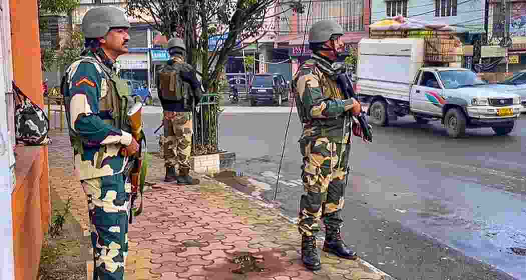 Security personnel stand guard in Imphal.