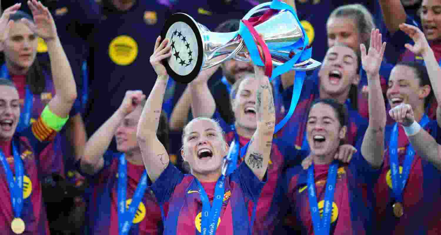 Barcelona's Claudia Pina celebrates with the trophy after winning the Women's Champions League final soccer match between FC Barcelona and OL Lyonnes, in Oslo, Saturday, May 23, 2026.