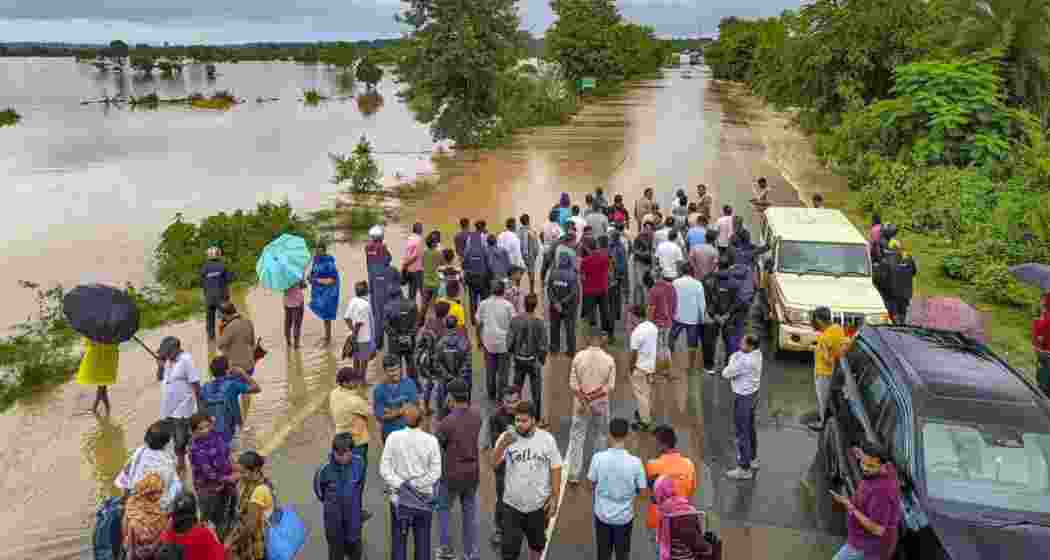 Rising river levels in Assam and adjoining Northeast regions after IMD forecast heavy rainfall, with Central Water Commission issuing advisory and authorities monitoring Brahmaputra and Barak river systems closely continuously. (Photo from Assam during floods)