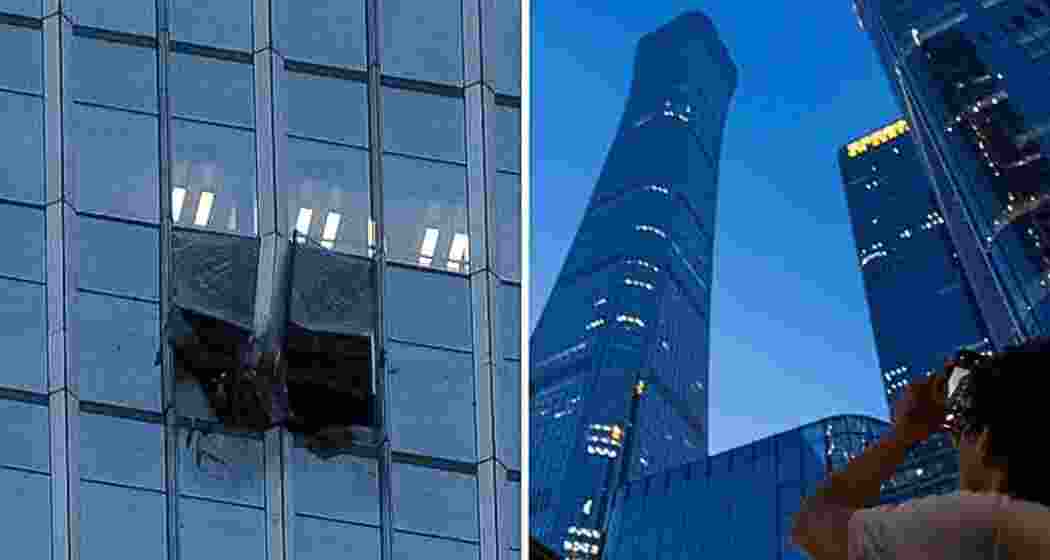 A man looks at damage to the CITIC Tower, also known as China Zun, after a light aircraft crashed into the skyscraper in Beijing, China, on Friday. AP/PTI