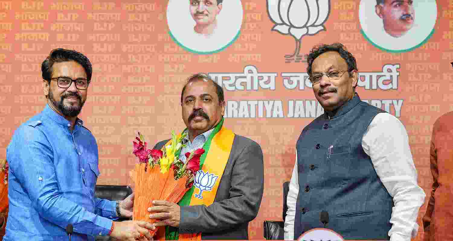 Former Indian Air Force chief, Air Chief Marshal (Retd) RKS Bhadauria with Union Minister Anurag Thakur and party General Secretary Vinod Tawde in New Delhi on Sunday.