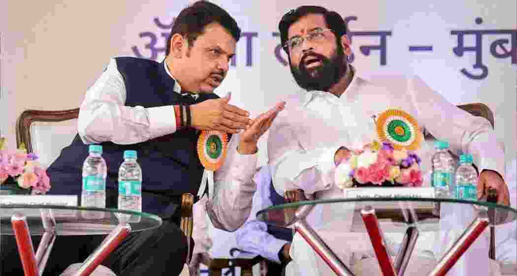 Maharashtra CM Devendra Fadnavis interacts with chairman of Shiv Sena, Eknath Shinde. 