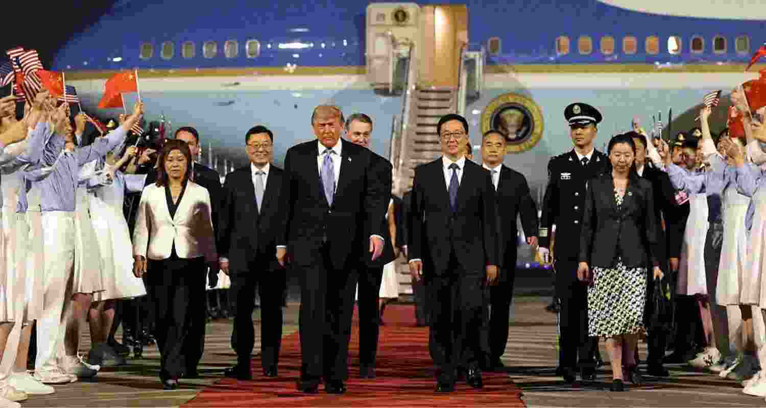 US President Donald Trump is joined by China's Vice-President Han Zheng and other Chinese officials as he arrives in Beijing on Wednesday.