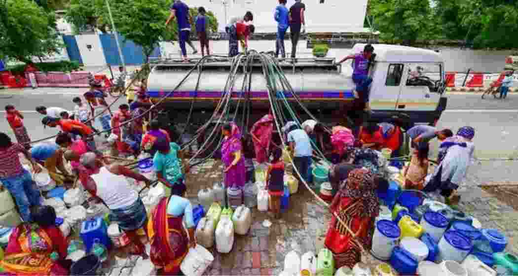 People queued up to fetch water in Bengaluru. People queued up to fetch water in Bengaluru.