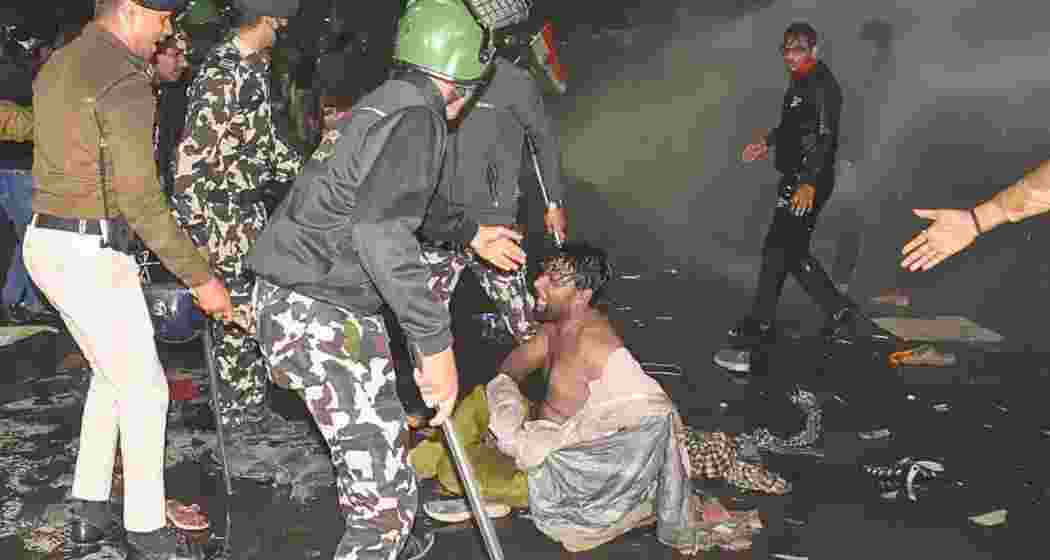 Police personnel detain aspirants protesting against the alleged paper leak and irregularities in the BPSC 70th Integrated Combined Competitive Examination (CCE) on Sunday in Patna, Bihar.