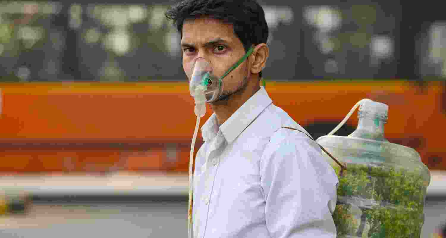 A protester wears an oxygen mask during a protest against air pollution, near the Parliament House complex, in New Delhi, Wednesday, Nov. 27, 2024. Pollution levels in Delhi decreased slightly on Wednesday morning with the air quality nearing the 'poor' category.