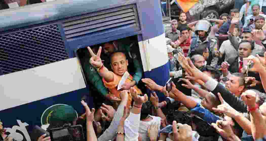 Hindu leader Chinmoy Krishna Das Brahmachary being dragged inside a police van following his arrest in Chattogram, Bangladesh over sedition charges.