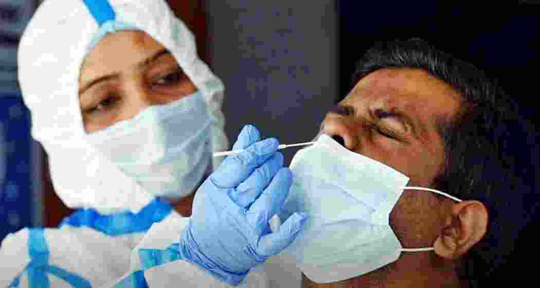A healthcare worker carefully collects a nasal swab sample from a man to test for COVID-19. Representative image.