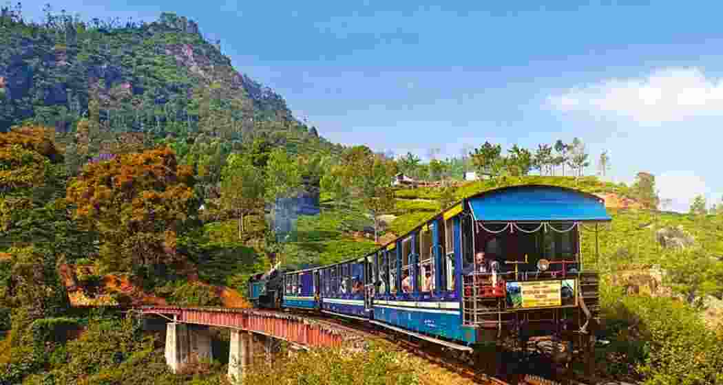 The iconic Darjeeling toy train chugs through the hills. The iconic Darjeeling toy train chugs through the hills.