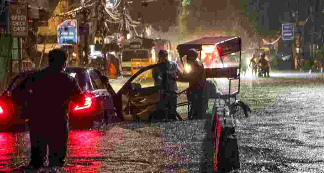 Delhi rain record waterlogging roads flooding imd rain alerts.