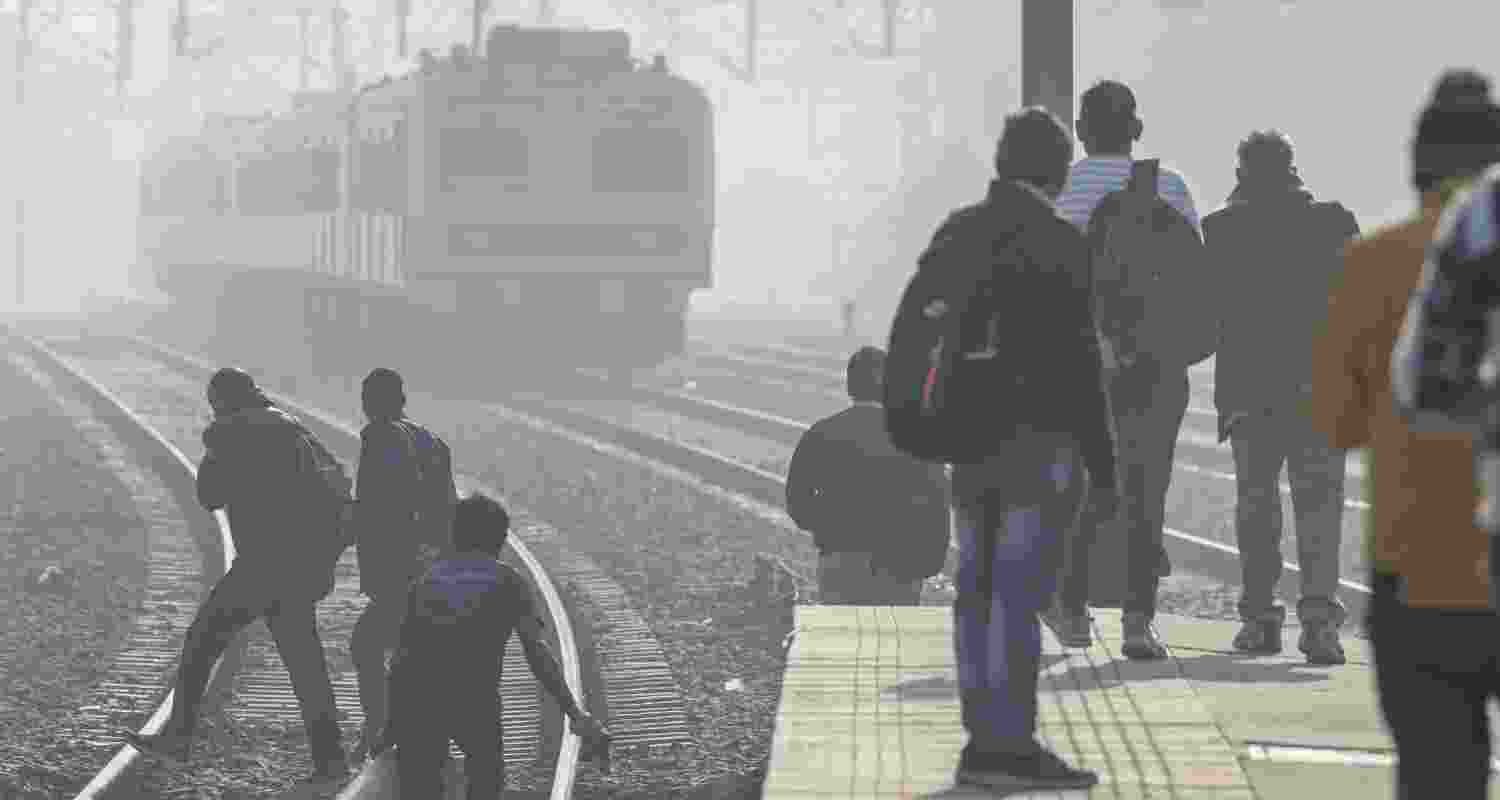 People wait at a railway platform in New Delhi. 