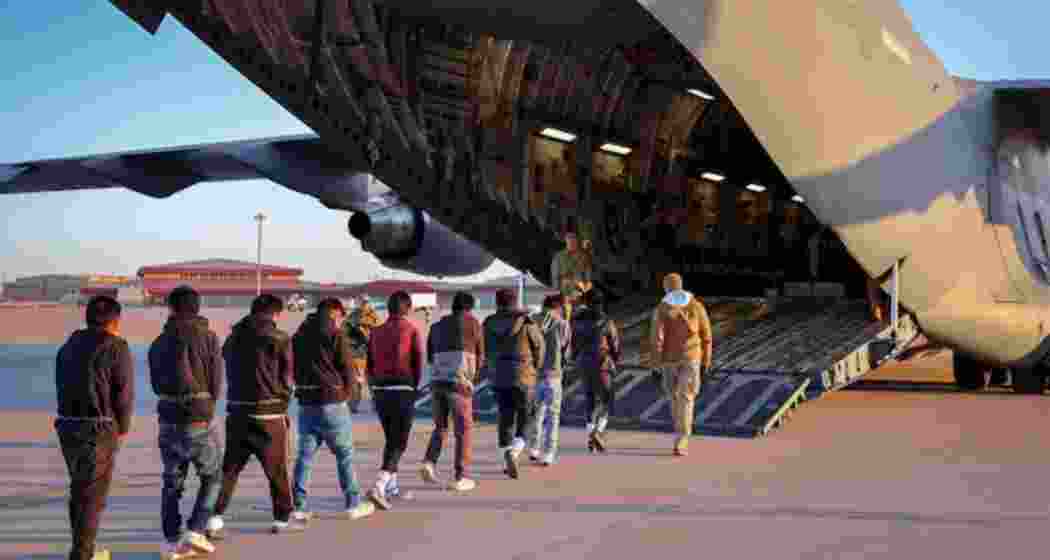 A batch of illegal immigrants from India boarding a US military plane in shackles. (Image: PTI)