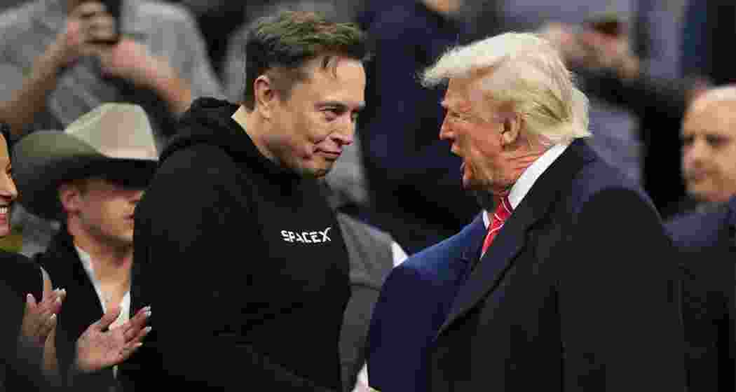 Elon Musk, shakes hands with President Donald Trump at the finals for the NCAA wrestling championship, on March 22, 2025, in Philadelphia. 