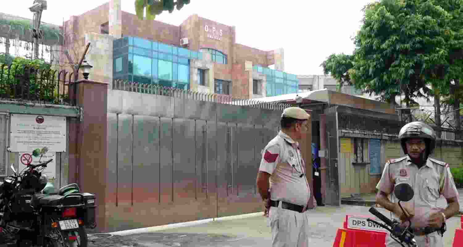 Police personnel outside Delhi Public School (DPS) that received a bomb threat on Monday, at Dwarka, in New Delhi, Monday.
