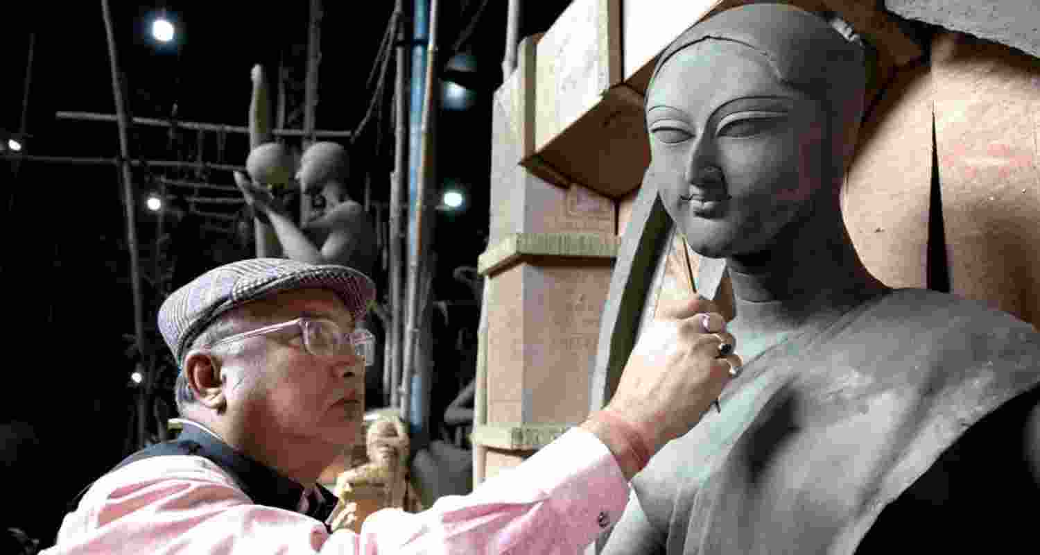Sanatan Rudra Pal works on an idol before being felicitated at an event, celebrating his recognition as a Padma Shri awardee from West Bengal.