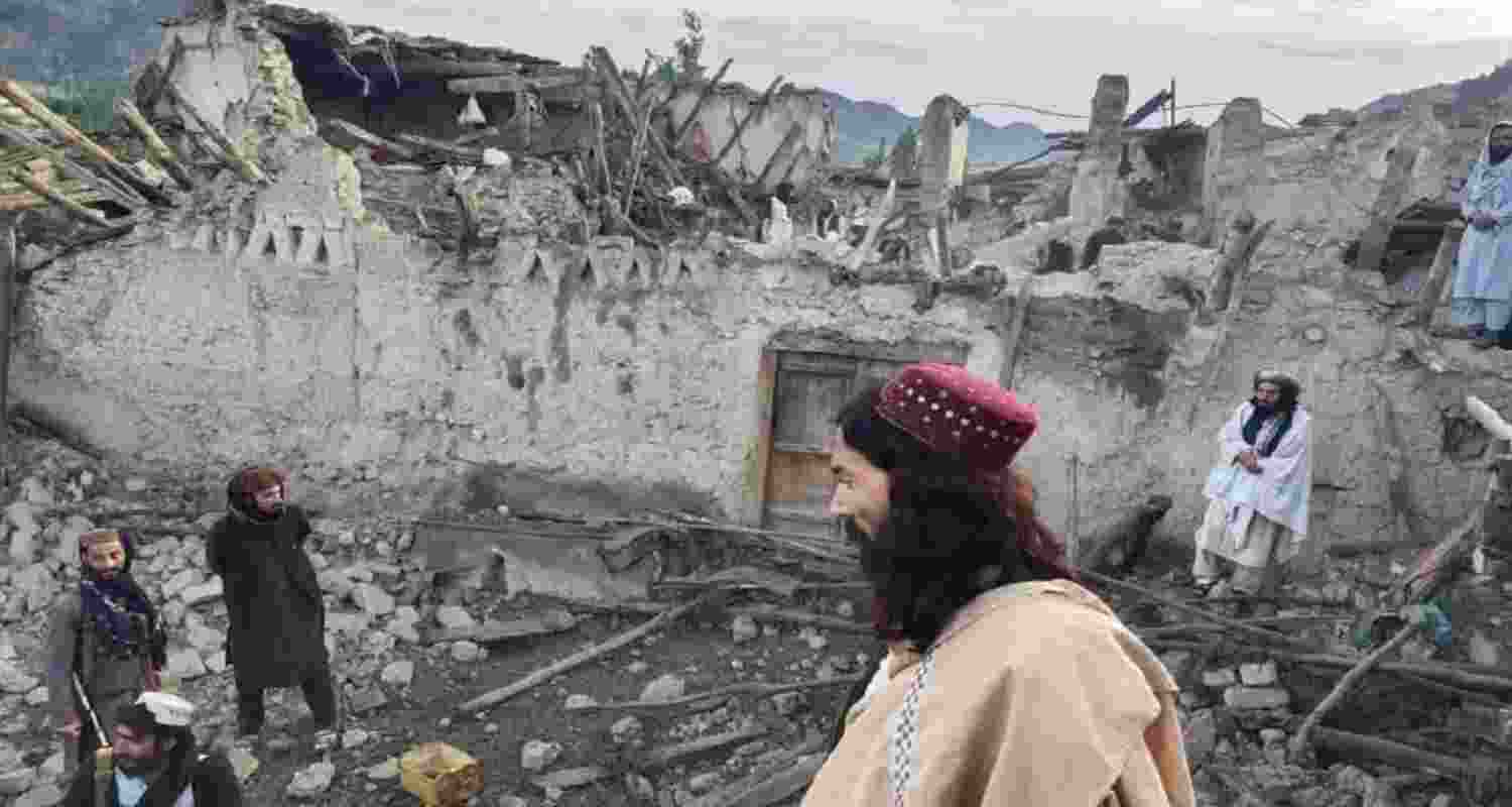 Afghans look at the destruction caused by an earthquake in the province of Paktika, eastern Afghanistan, Wednesday.