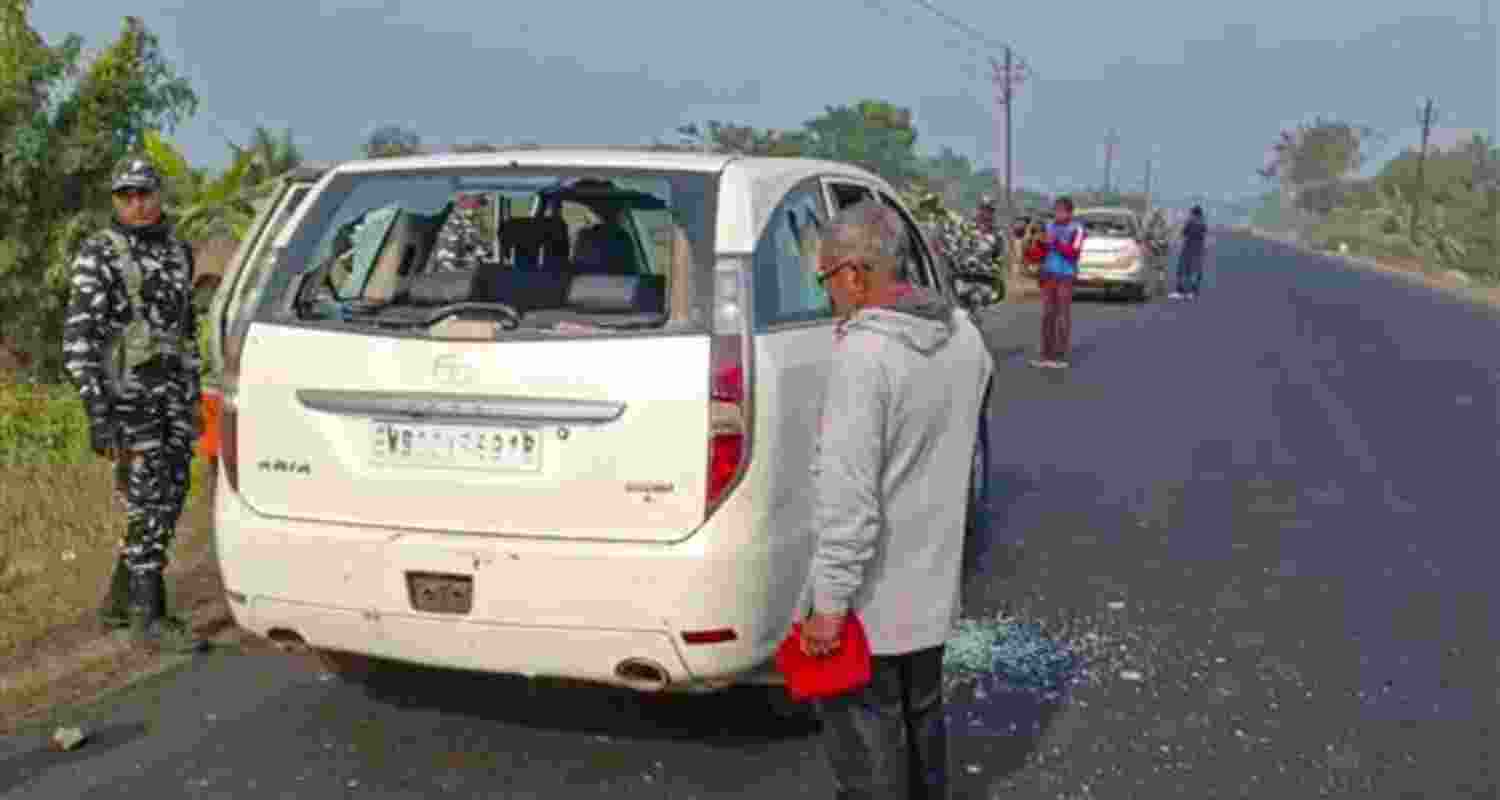 Security personnel with others stand near a vehicle which was allegedly damaged by the supporters of TMC leader during a raid by ED officials, in West Bengal's North 24 Parganas district on January 5. Security personnel with others stand near a vehicle which was allegedly damaged by the supporters of TMC leader during a raid by ED officials, in West Bengal's North 24 Parganas district on January 5.