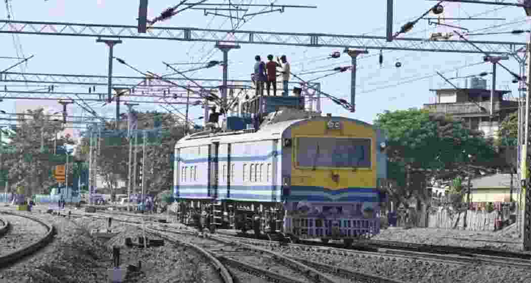 Railway technicians carry out repair work at a busy railway junction as Indian Railways advances network modernisation and near-total electrification.