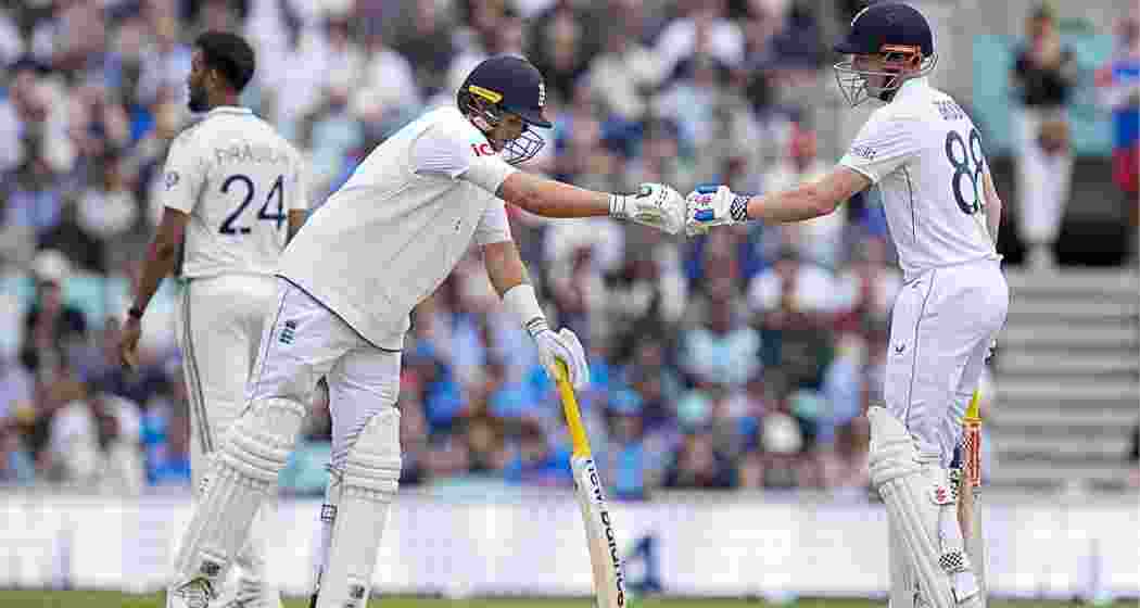 England's Harry Brook celebrates his half century with teammate Joe Root during the fourth day of the fifth Test match between India and England, at The Oval cricket ground, in London on Sunday. England's Harry Brook celebrates his half century with teammate Joe Root during the fourth day of the fifth Test match between India and England, at The Oval cricket ground, in London on Sunday.