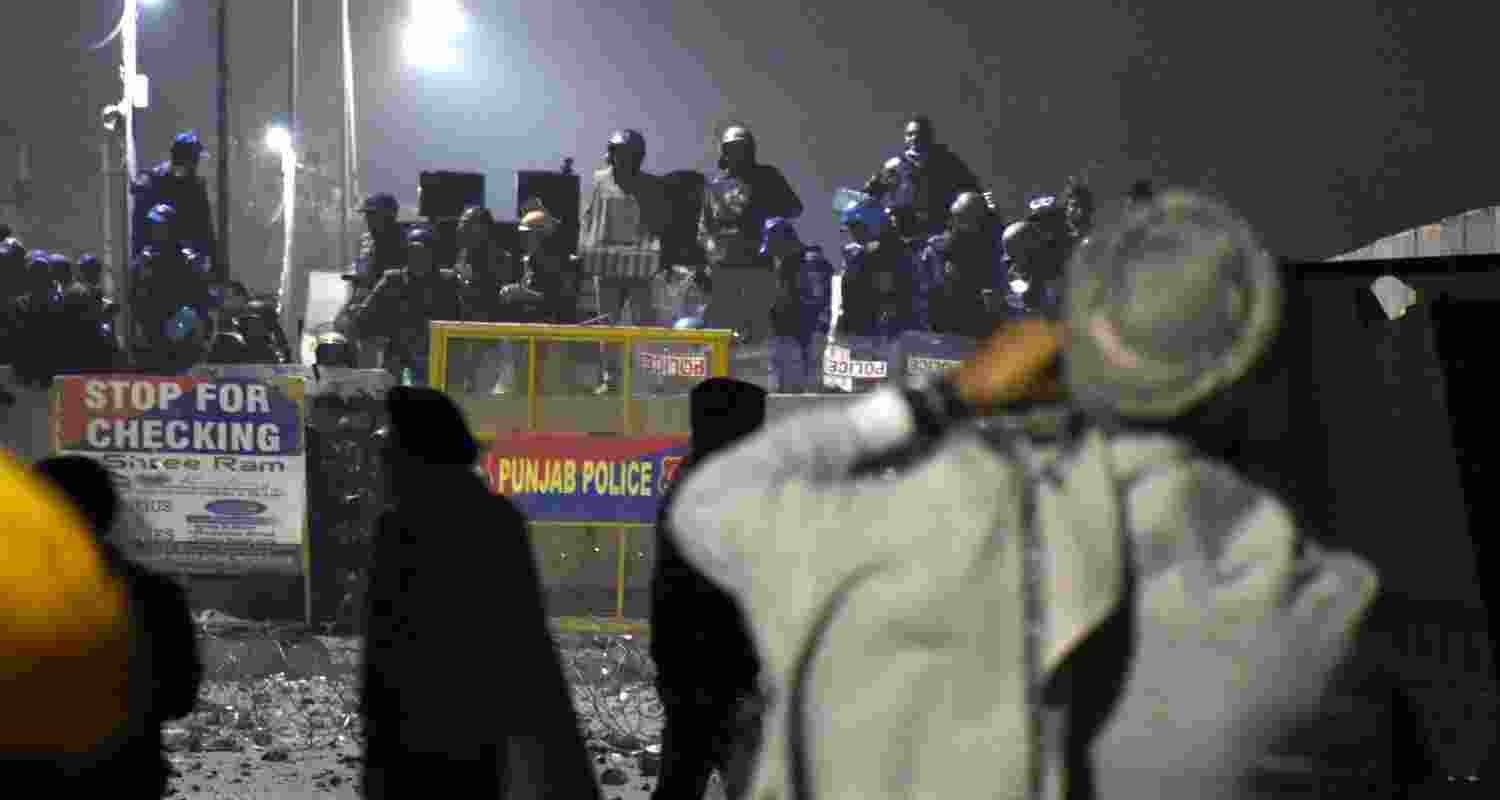 Security personnel stand guard at a roadblock at the Shambhu Border amid farmers' protest during the Samyukta Kisan Morcha. Security personnel stand guard at a roadblock at the Shambhu Border amid farmers' protest during the Samyukta Kisan Morcha.