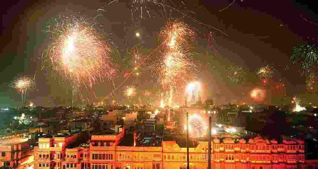 Firecrackers light up the sky as dense smog engulfs New Delhi during Diwali celebrations.