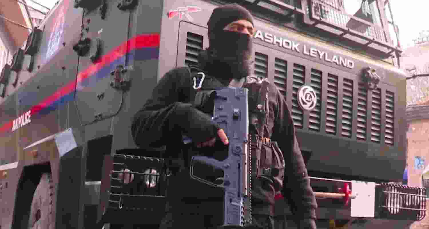 A security personnel stands guard on a road amid a joint operation by Indian Army & J&K Police, in Srinagar, Tuesday, Dec. 3, 2024. A terrorist was gunned down in an encounter with security forces in the Dachhigam forest area of Srinagar on Tuesday. 