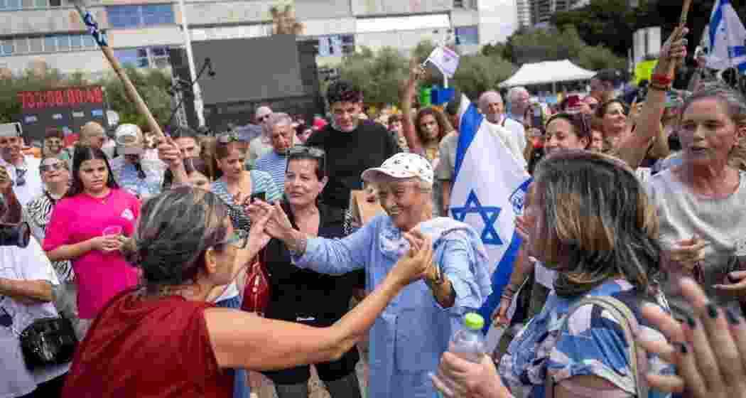 People react as they gather to watch a live broadcast of Israeli hostages released from Gaza at a plaza known as hostages square in Tel Aviv, Israel, Monday.