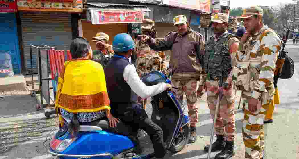 Security personnel providing guidance to commuters regarding alternative routes to navigate amidst the aftermath of the violence in Haldwani, Uttarakhand. Security personnel providing guidance to commuters regarding alternative routes to navigate amidst the aftermath of the violence in Haldwani, Uttarakhand.