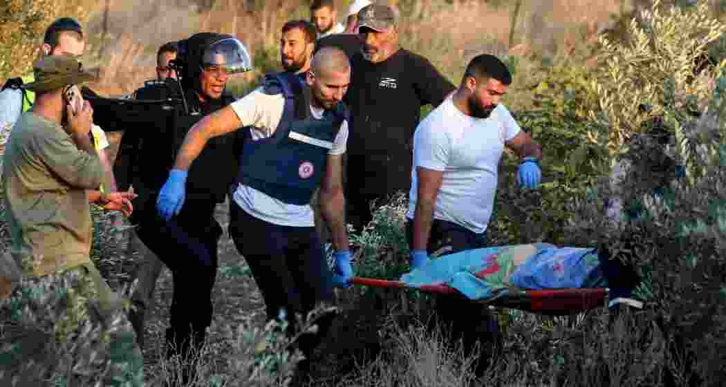 First responders transport the shrouded body of a woman killed by a rocket fired from Lebanon, which struck near Kiryat Ata on October 31.