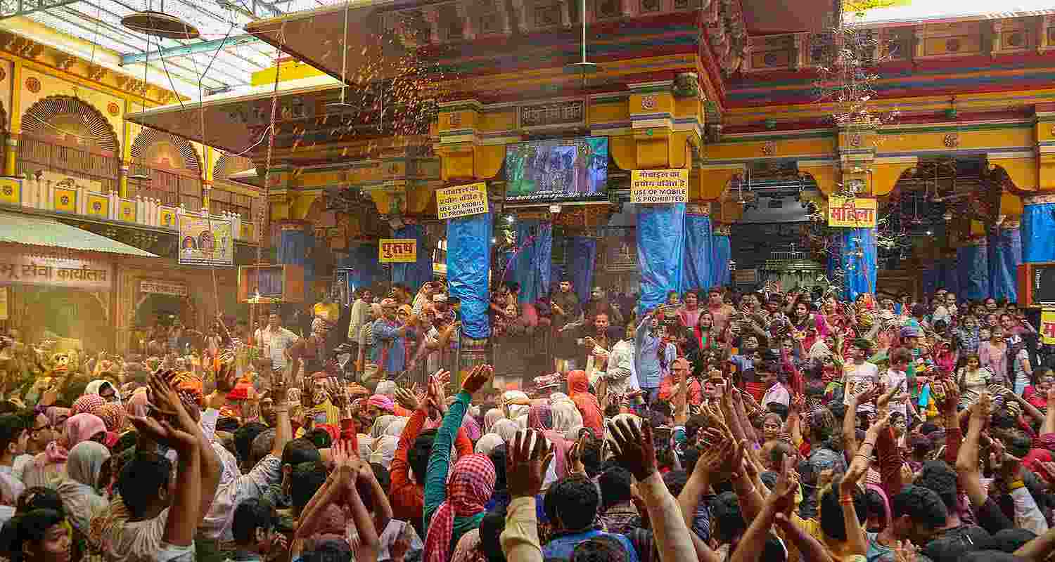 Devotees celebrate with colours during Holi celebration at the Dwarkadhish Temple, in Mathura, Wednesday