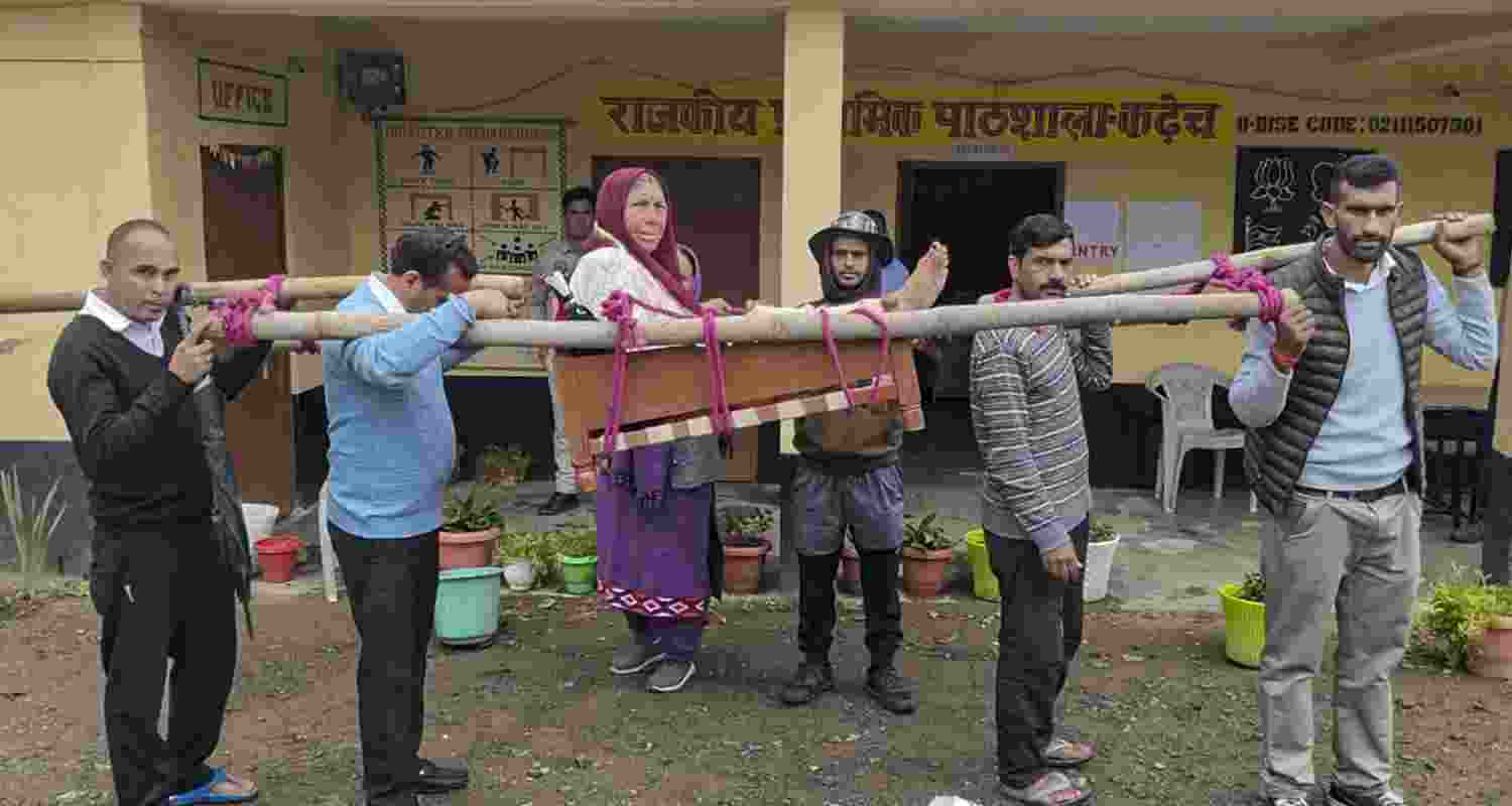 People carry an elderly woman on a palanquin to a polling booth to cast her vote during the Panchayat elections at Seri village, in Shimla, Himachal Pradesh, Saturday, May 30, 2026. 