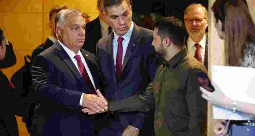 Prime Minister of Hungary Viktor Orban (L) and President of Ukraine Volodymyr Zelensky (R) shake hands beside Spain's Prime Minister Pedro Sanchez (C) prior to the opening ceremony of the third meeting of the European Political Community (EPC) Summit at the Congress Hall in Granada, Spain, 05 October 2023.
