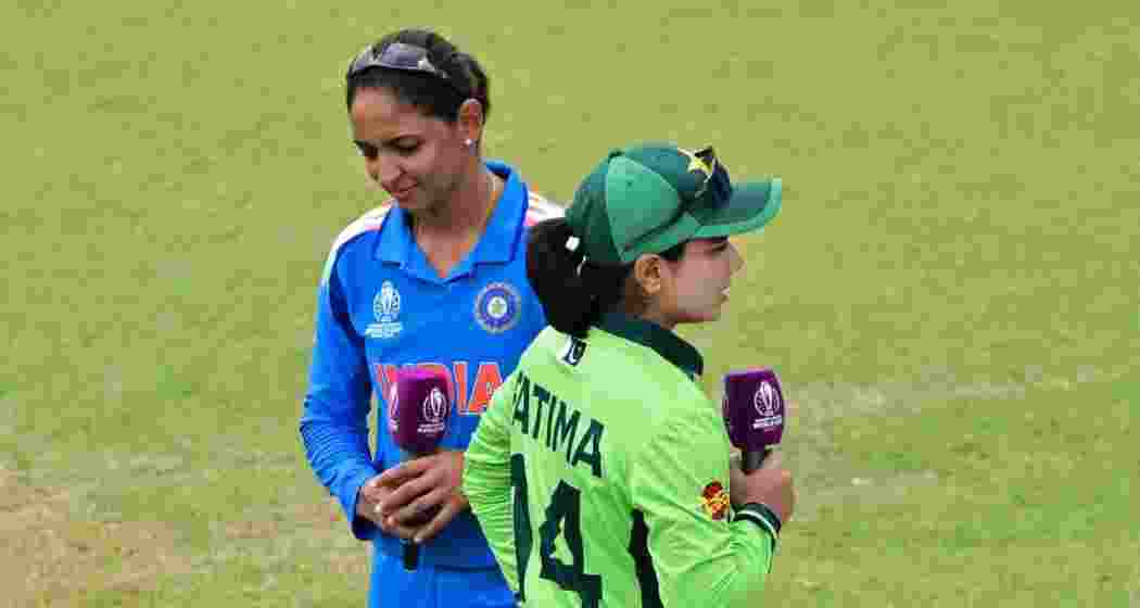 India captain Harmanpreet Kaur and her Pakistani counterpart Fatima Sana walk past after the toss ahead of the Women’s ODI World Cup 2025 match. 