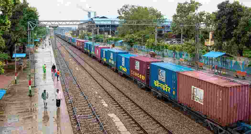 A cargo train stationed at a railway platform. 