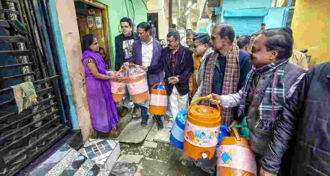 Members of social organisations distribute drinking water containers to residents of Bhagirathpura following contaminated water crisis, in Indore on Saturday. Members of social organisations distribute drinking water containers to residents of Bhagirathpura following contaminated water crisis, in Indore on Saturday.
