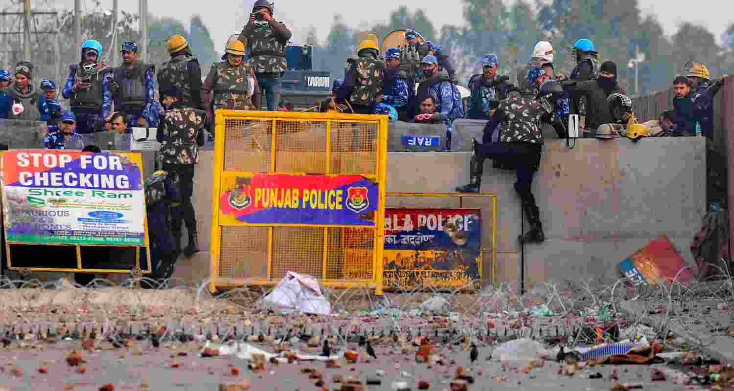 Security personnel stand guard during the farmers' protest over various demands, including a legal guarantee on the minimum support price (MSP) for crops and farm loan waiver, at the Punjab-Haryana Shambhu Border. 