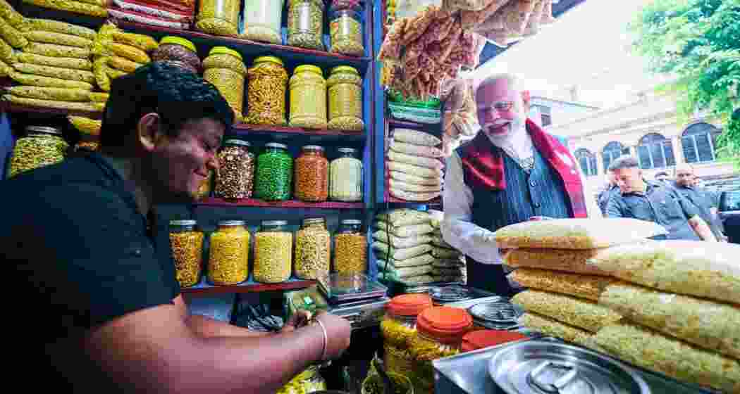 Prime Minister Narendra Modi at the jhalmuri stall during campaigning for the 2026 West Bengal Assembly elections in Jhargram on April 19. (File photo)