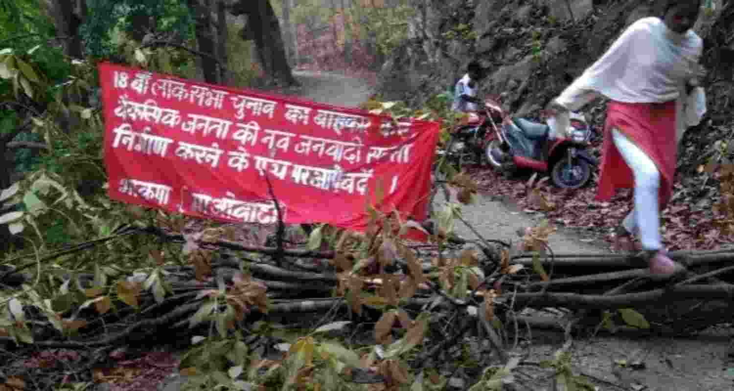 Maoists cut down trees and declare election boycott along rural road in Saranda forest. Maoists cut down trees and declare election boycott along rural road in Saranda forest.
