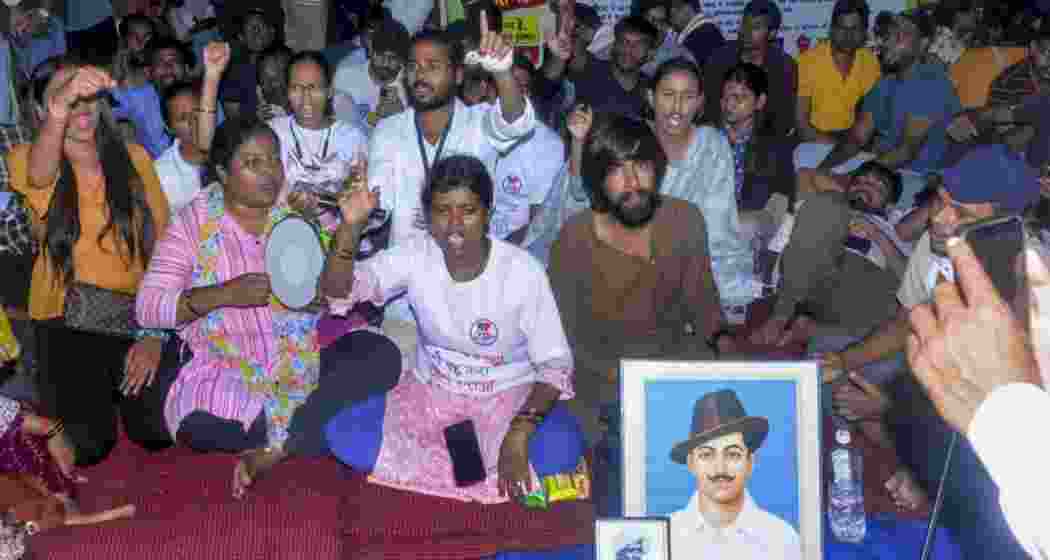 Students and aspirants raise slogans during a protest demanding a probe into alleged recruitment exam irregularities.