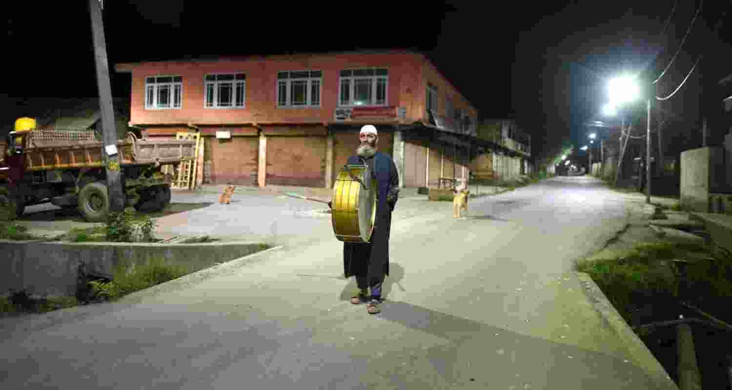 A Kashmiri man 'Sahar Khan' (human alarm) walks through a street to wake up Muslims for pre-dawn meals (Sehri) on the first day of the holy month of Ramzan. Image: X A Kashmiri man 'Sahar Khan' (human alarm) walks through a street to wake up Muslims for pre-dawn meals (Sehri) on the first day of the holy month of Ramzan. Image: X