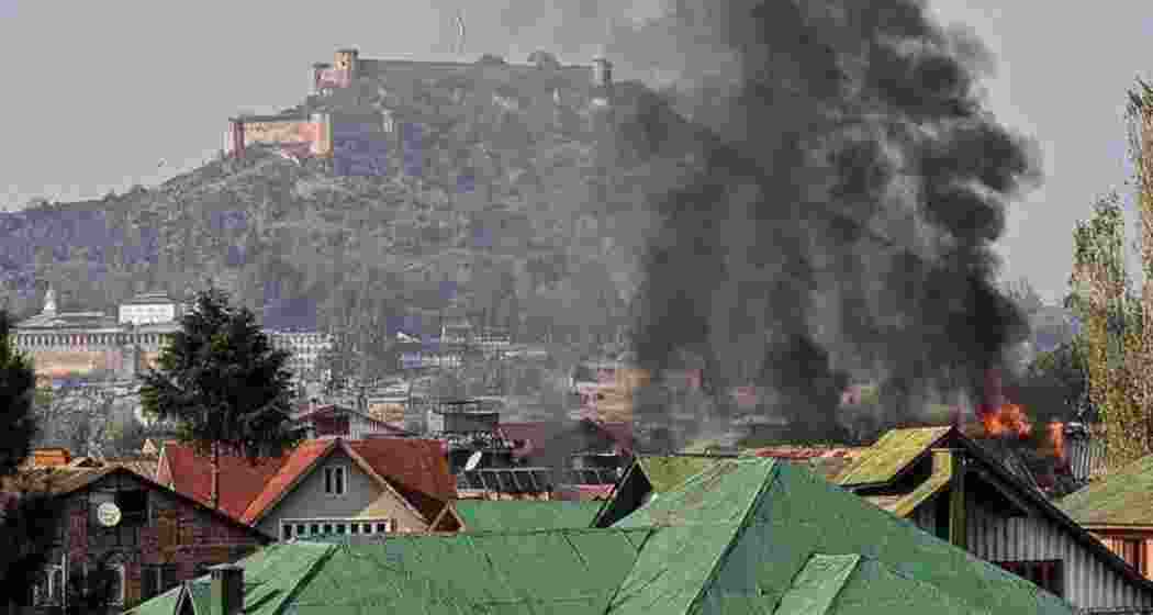 A house engulfed in flames following a fierce gunfight between security forces and militants in Jammu and Kashmir.